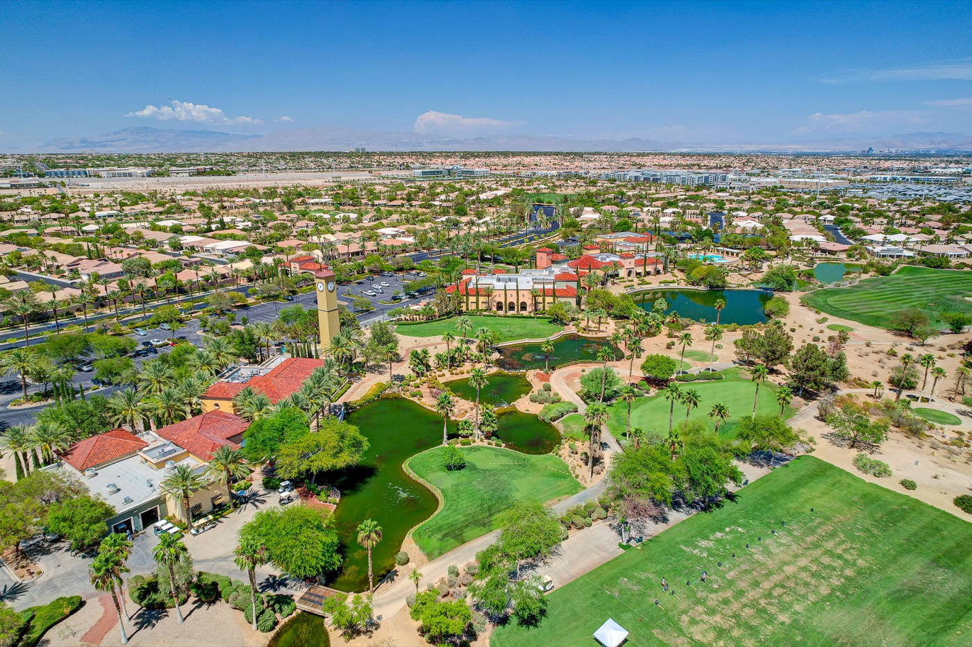 Aerial view of a Summerlin 55+ golf community with the Las Vegas Strip skyline in the distance